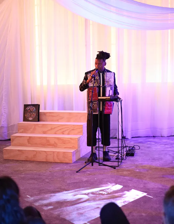 Artist performing on stage with dramatic lighting